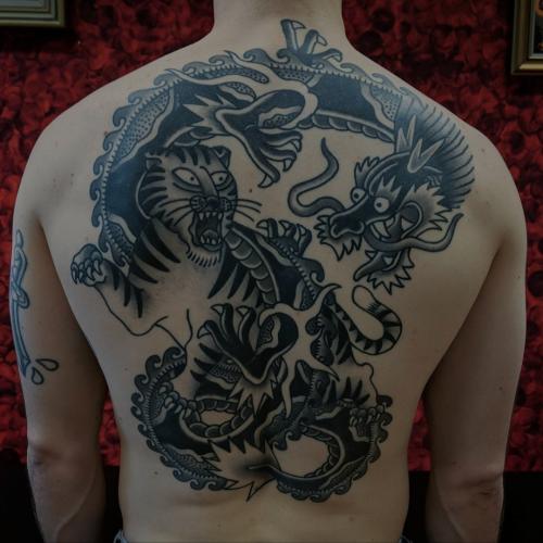traditional dragon tiger battle royale backpiece tattoo